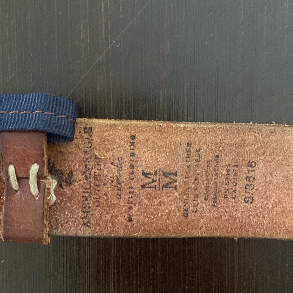 American eagle. Silver buckle, brown belt. Good used condition.